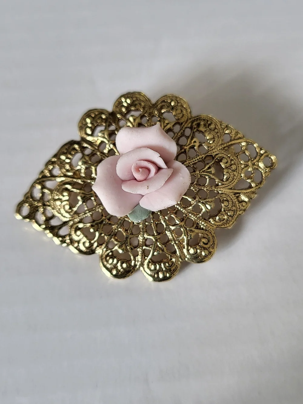 Vintage 1928 Brand Goldtone Filigree Brooch with Pink Porcelain Rose